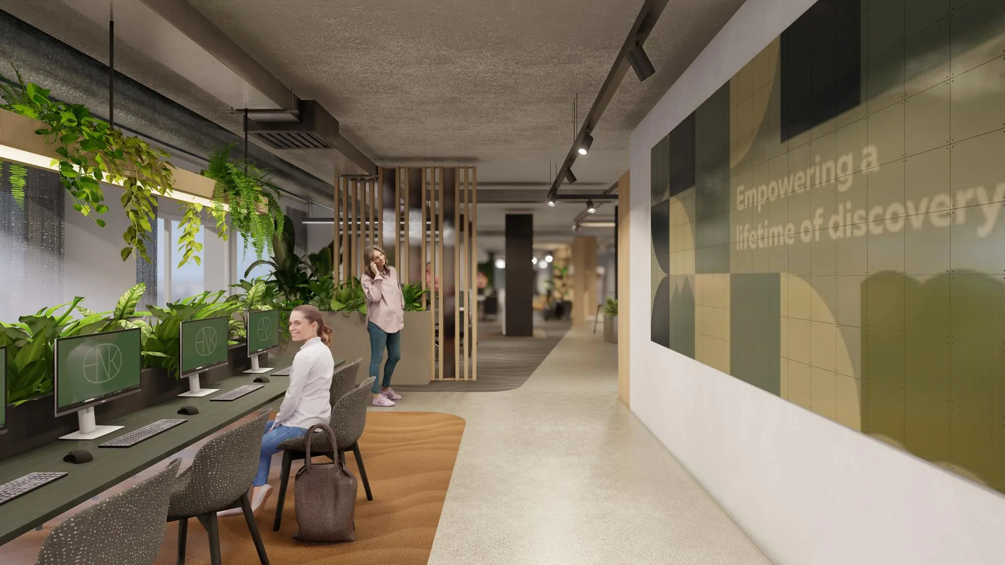 Moderne kantoorruimte aan de Marten Meesweg met werkplekken, hangplanten en een muurtegelkunst met de tekst "Empowering a lifetime of discovery".